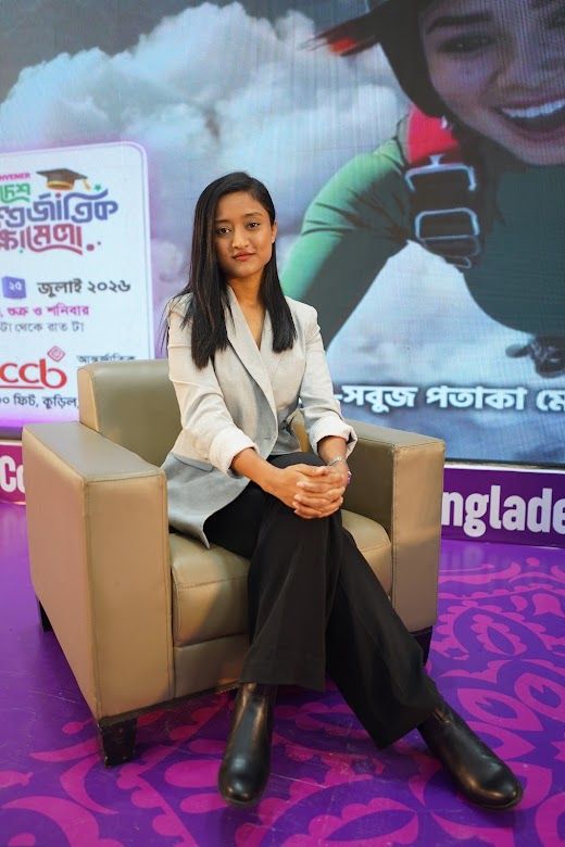 Presenter seated for a sofa interview in front of the BIEE backdrop