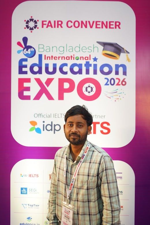 Exhibitor representative posed at the Education Expo IELTS backdrop