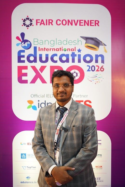 Exhibitor staff member portrait at the IDP IELTS backdrop
