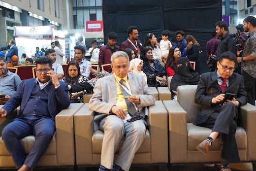 Visitors and delegates seated in the lounge/session area at the expo