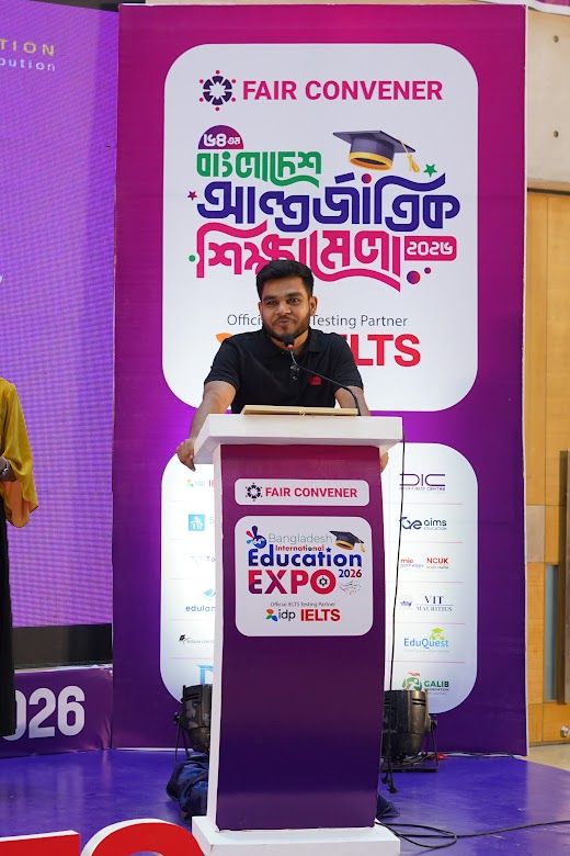 Speaker at the podium with Official Testing Partner IELTS backdrop