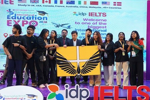 Participants group photo with the winged flag banner on stage