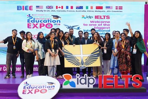 Team group photo holding the BIEE Education Expo banner